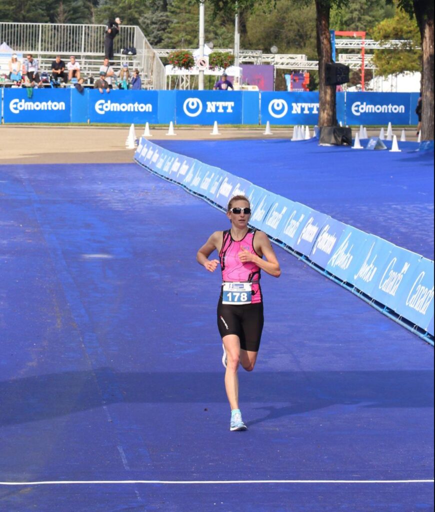 Andrea Opyr crossing triathlon finish line qualifying